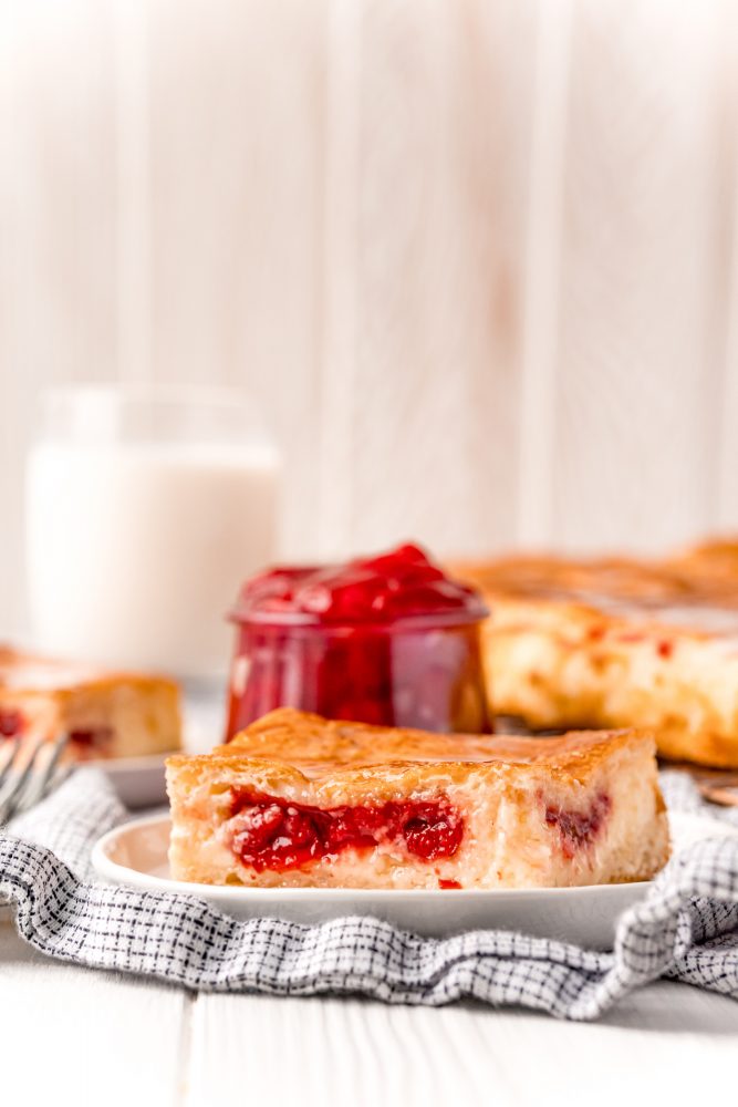 baked cherry cheesecake danish on a white plate