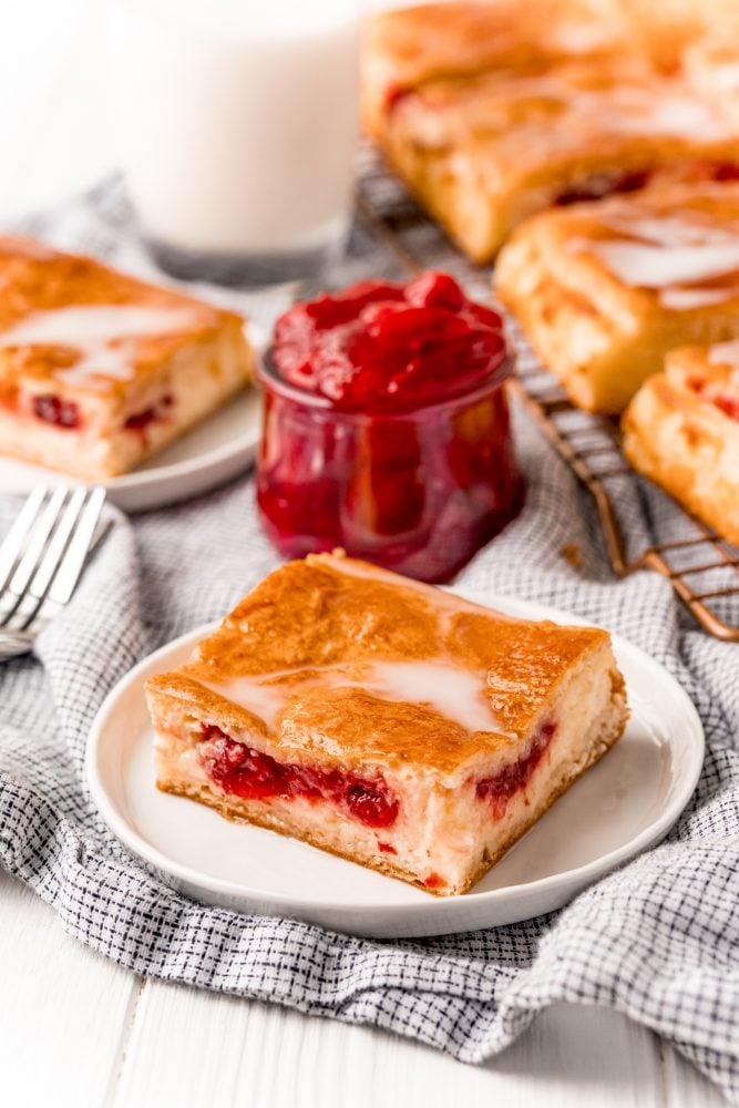 baked cherry cheesecake danish on a white plate