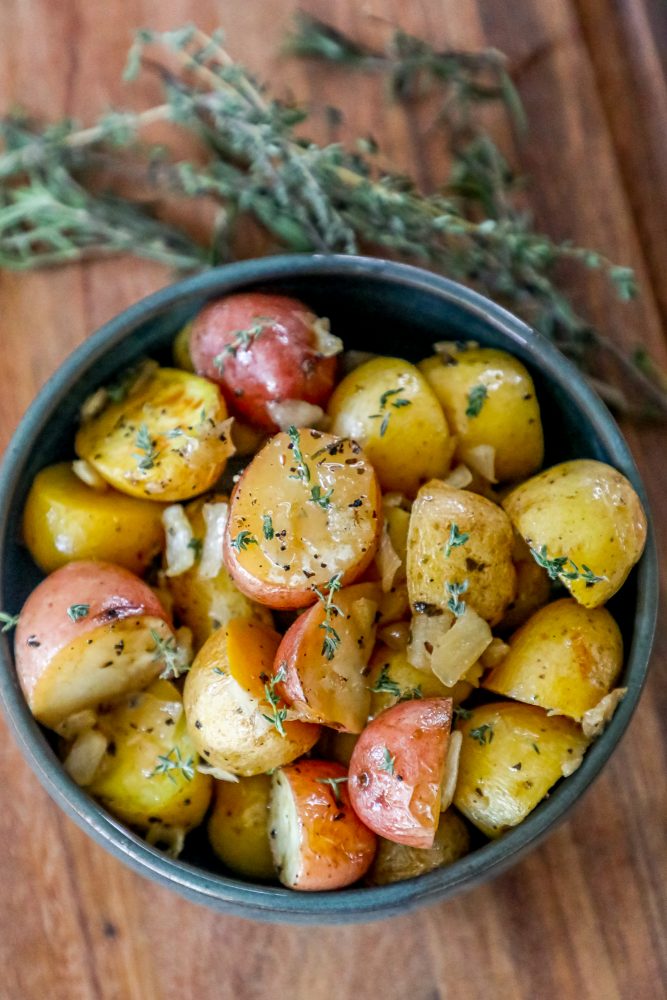 picture of roasted potatoes in a bowl with herbs and butter