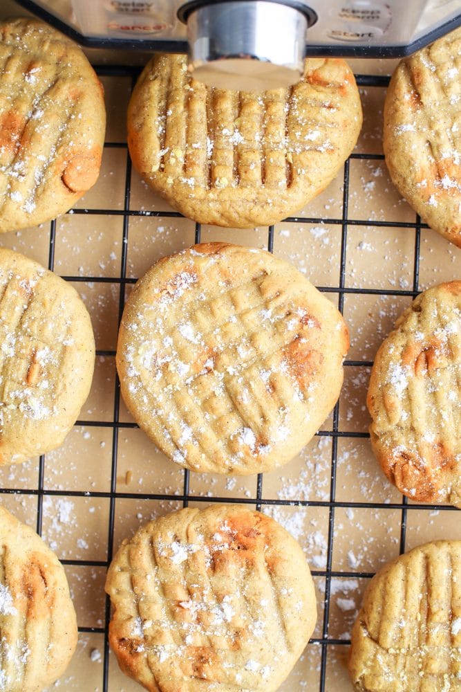 picture of pumpkin cookies with butterscotch chips on a cooling rack next to an air fryer