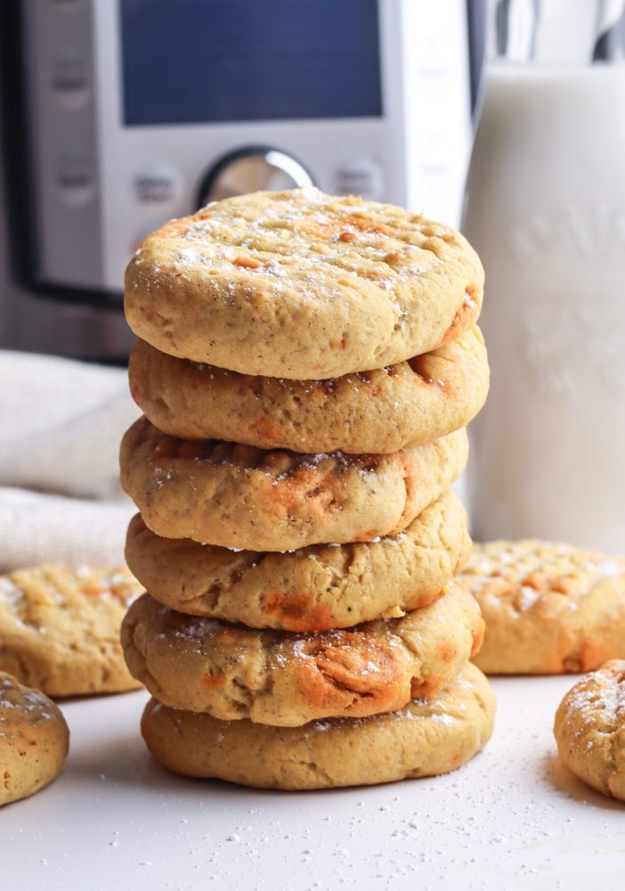 picture of pumpkin cookies with butterscotch chips on a cooling rack next to an air fryer