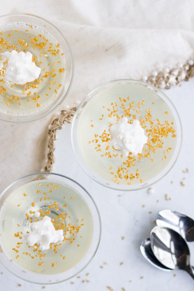 white jello shot with yellow sugar and cream on it