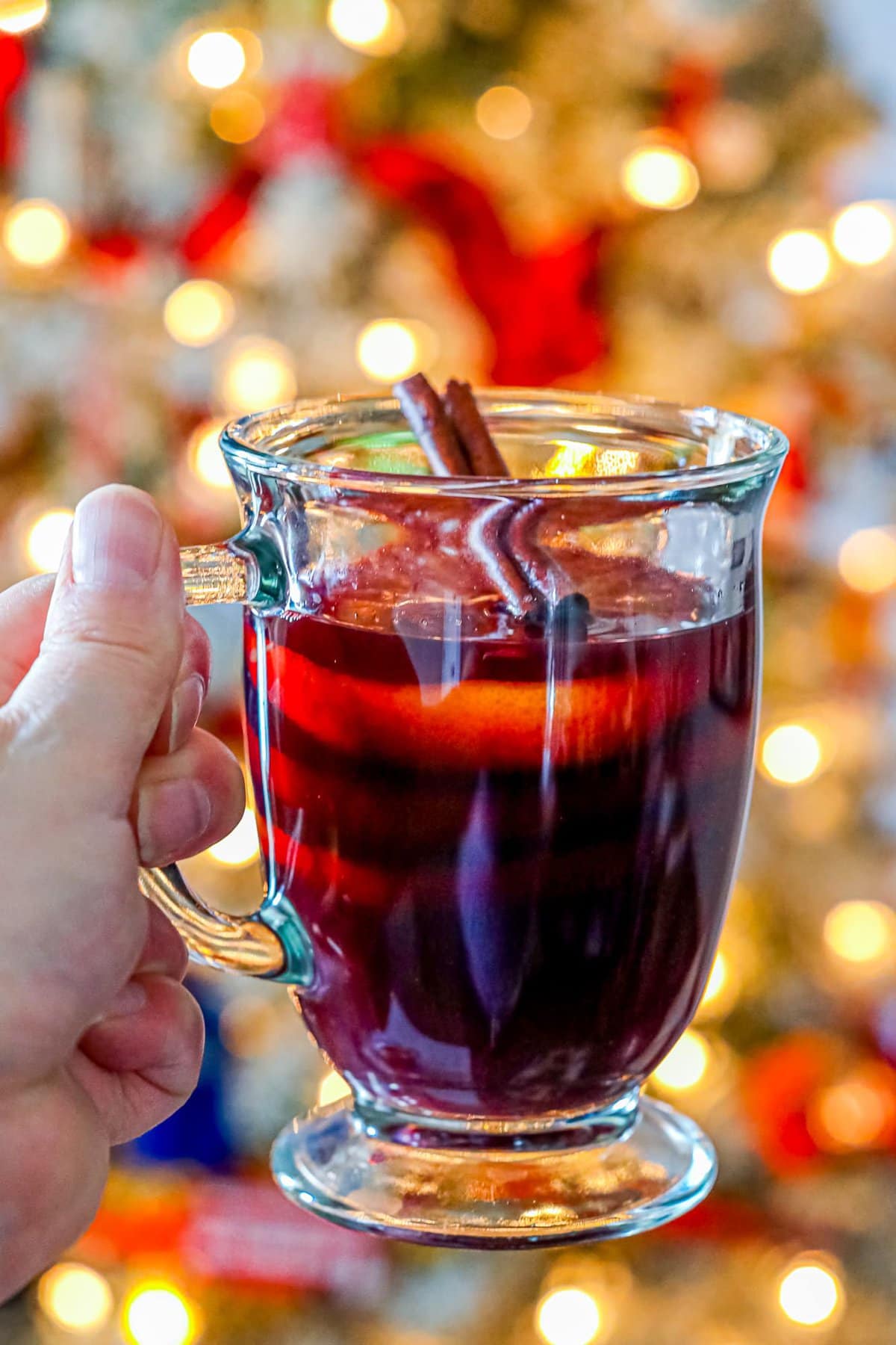 mug with rum punch in front of a christmas tree