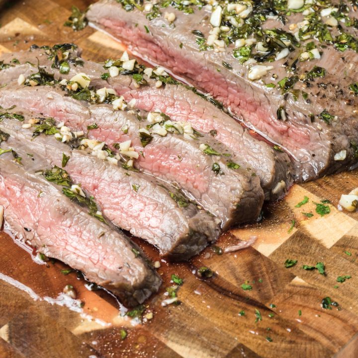 An easy London broil recipe featuring a delicious piece of steak on a cutting board.