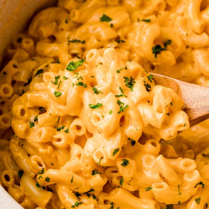 The Best Easy Mac and Cheese Recipe made in a pan with a wooden spoon.