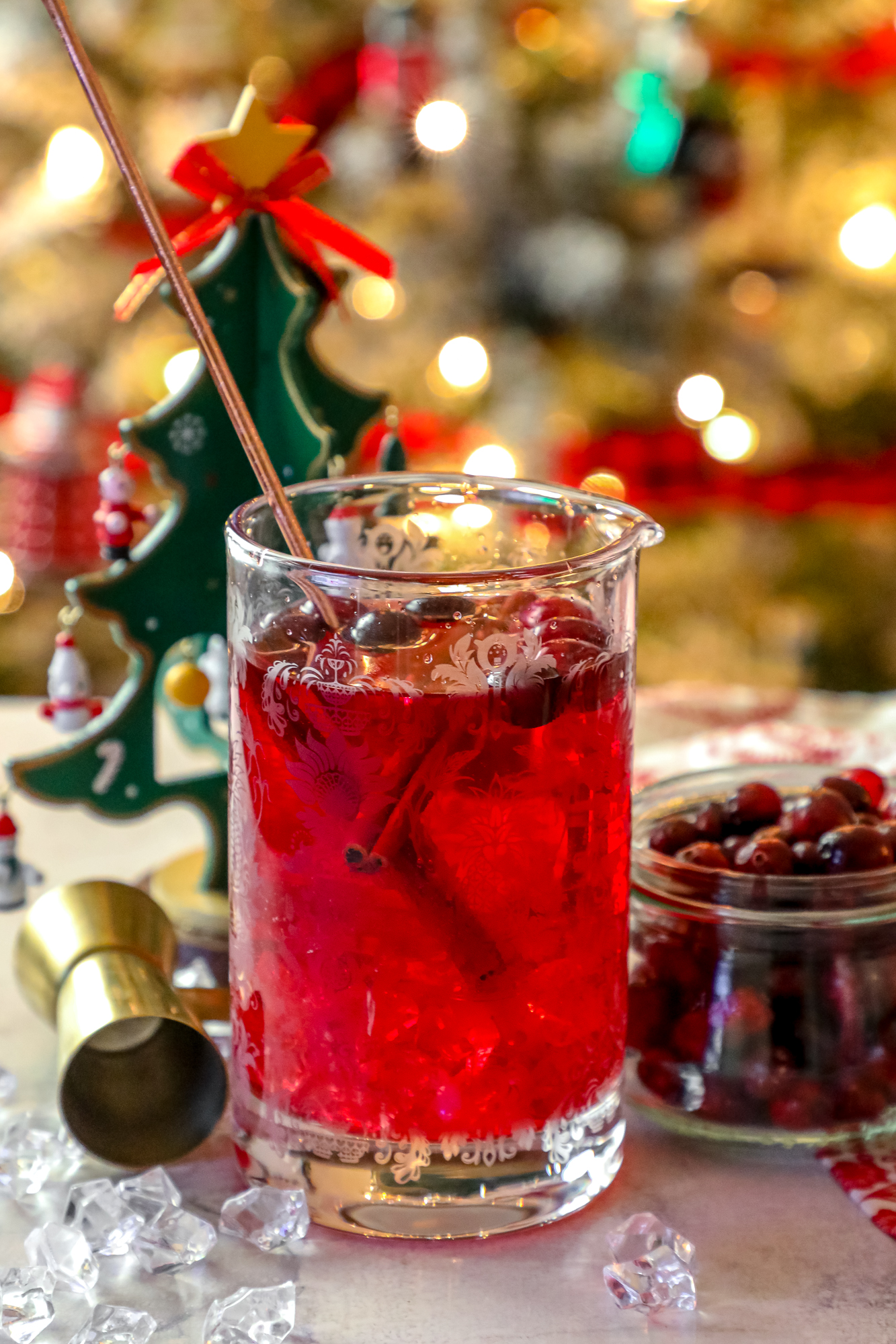 A glass of Easy Cranberry Sangria with Christmas decorations.