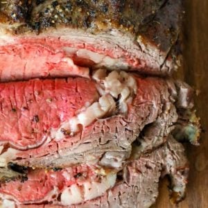 A prime rib, sliced and showcased on a cutting board to demonstrate an easy recipe.