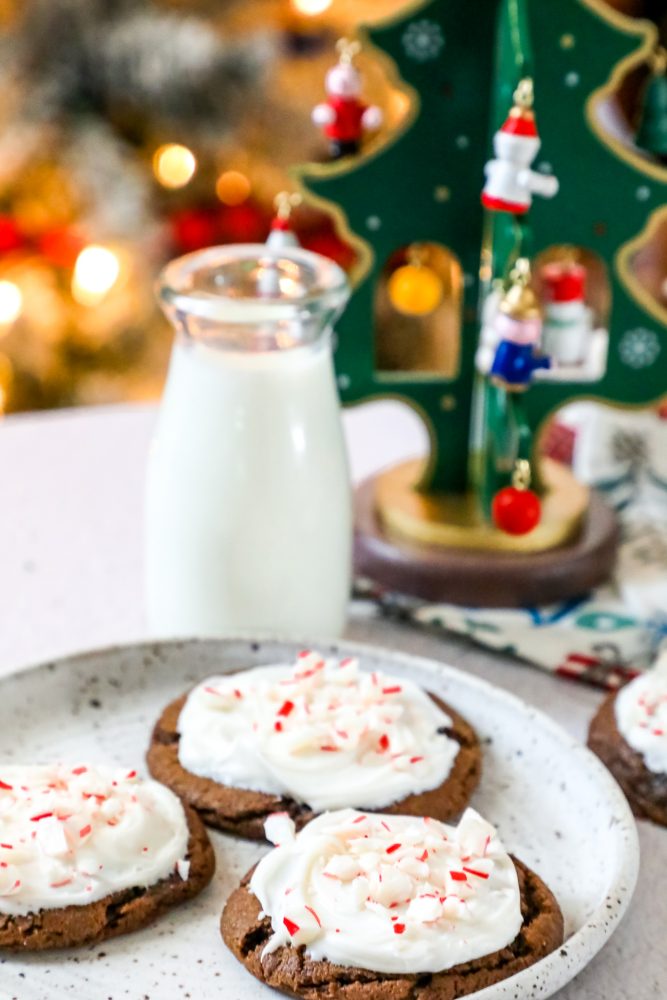 picture of chocolate cookies with frosting and pieces of crushed peppermint candy canes.