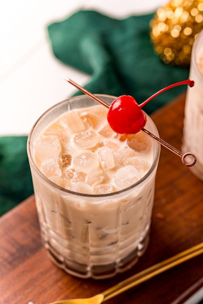 picture of a white russian in a glass with a cherry on a stick