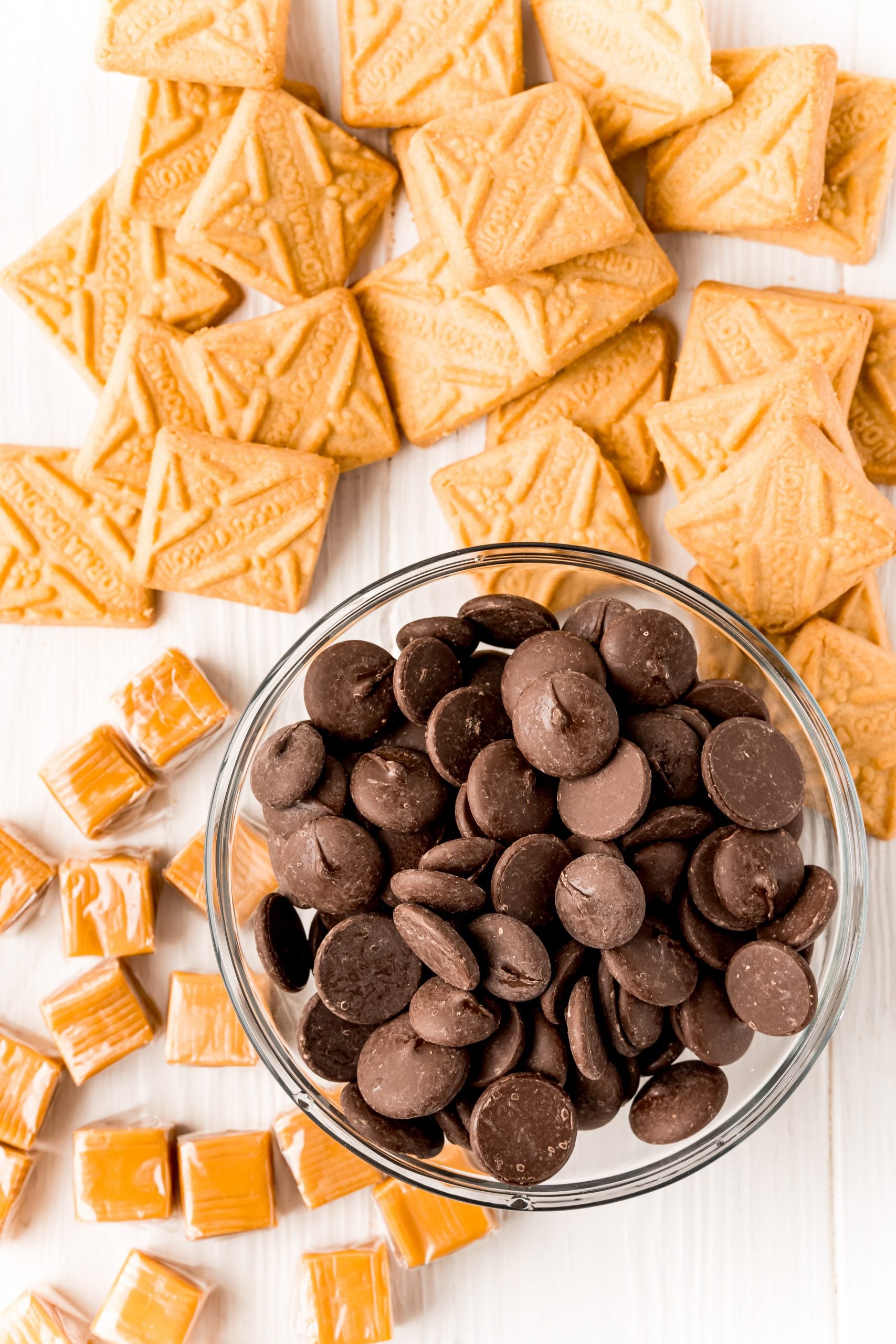 A bowl of chocolate chips and crackers, perfect for making Easy Millionaire Shortbread Bites or Shortcut millionaires bars.