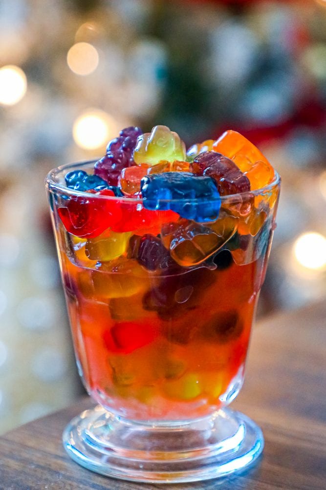 tall glass with gummy bears and liquor in it