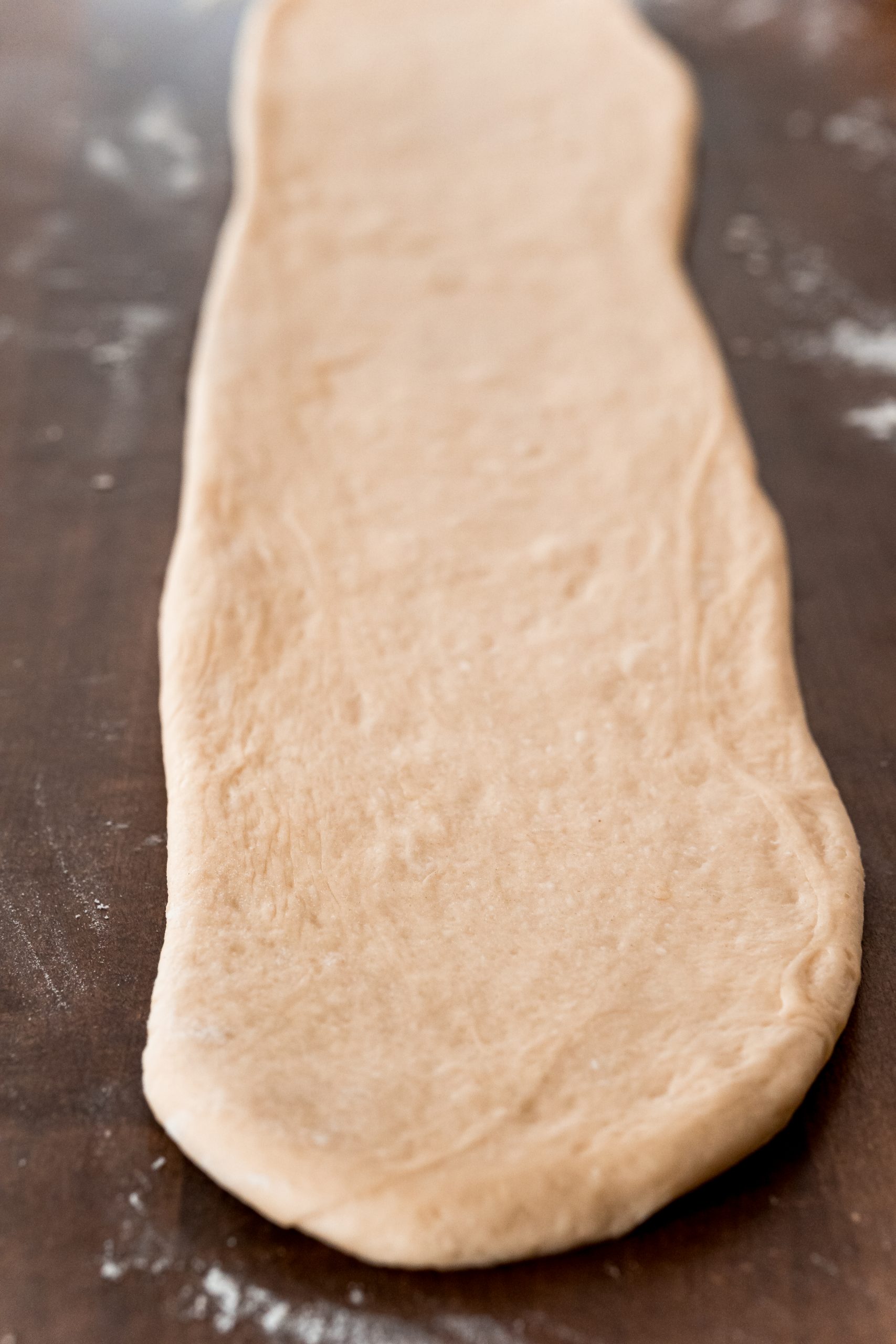 picture of roll dough flattened out onto table