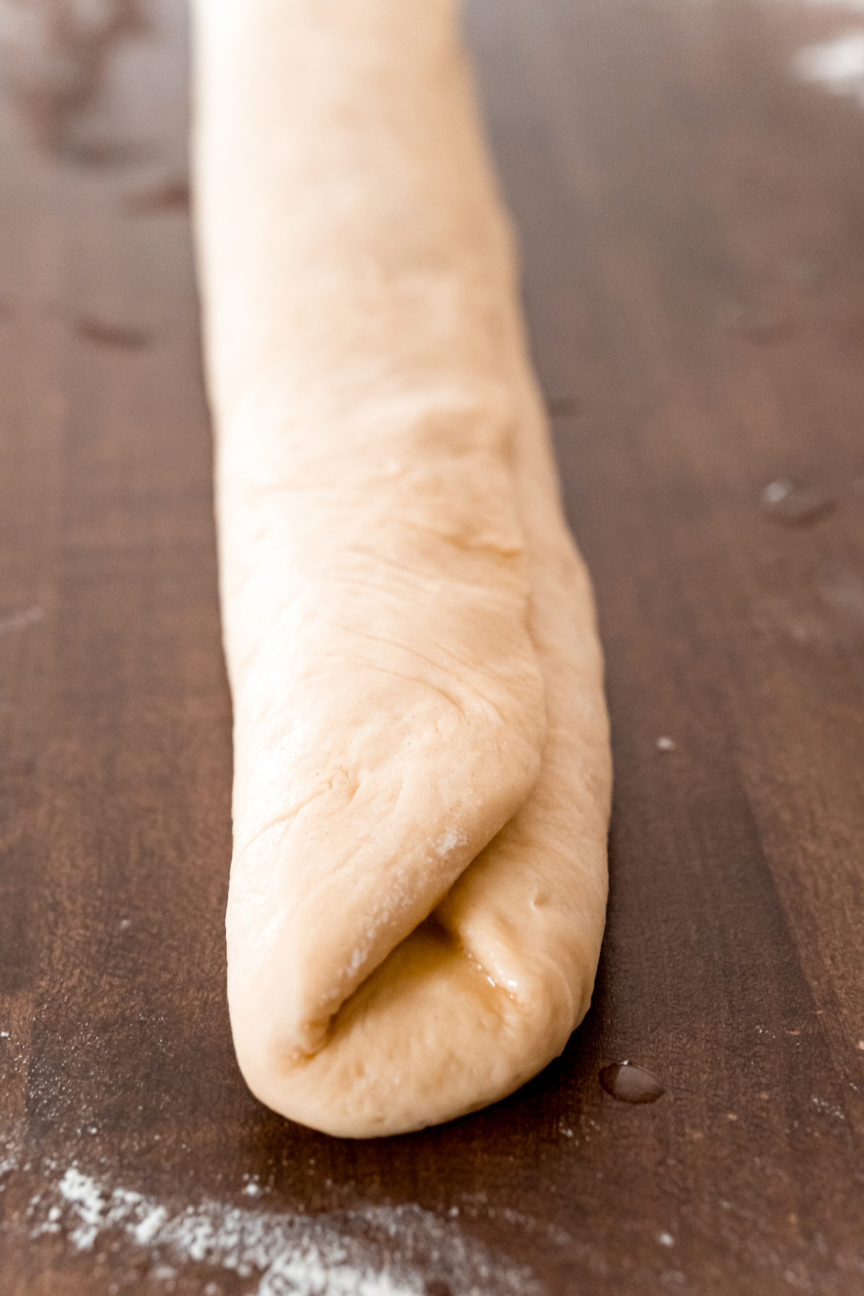 picture of bread roll being folded again on table