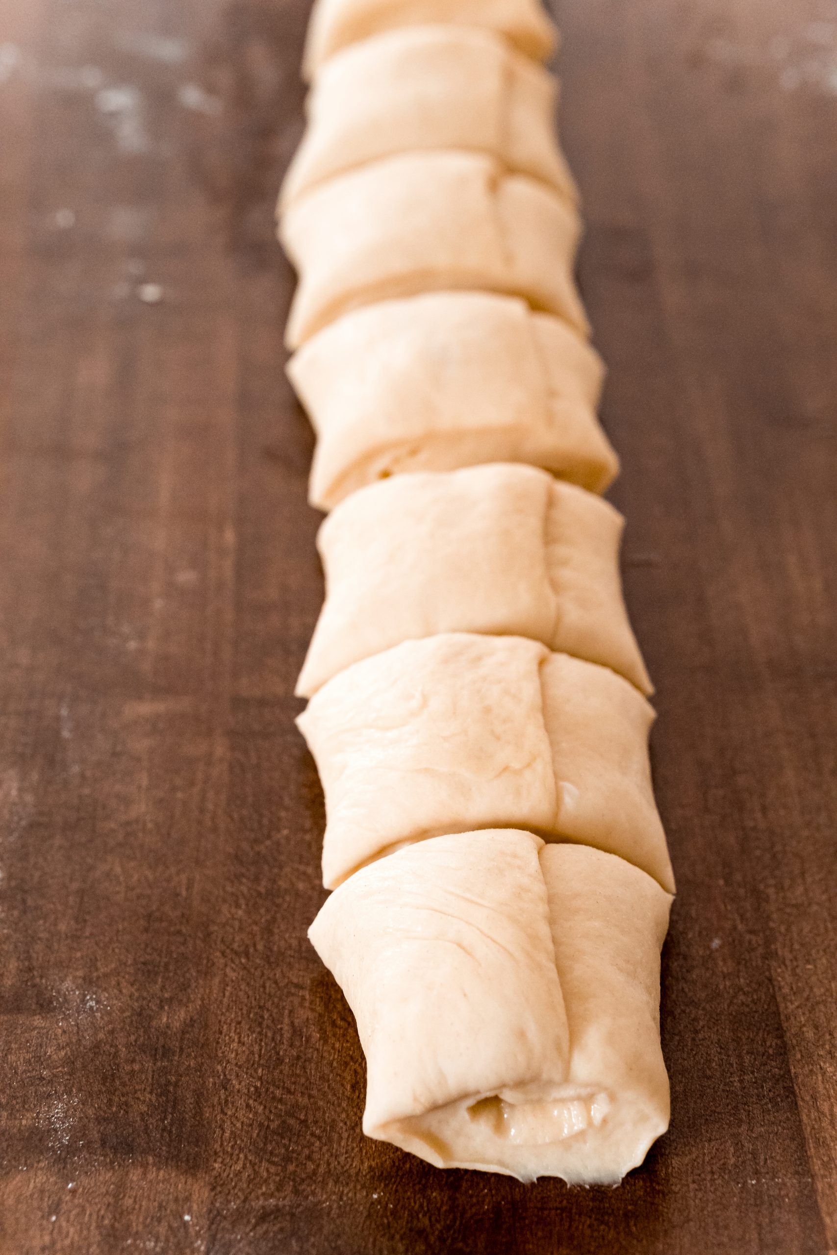 picture of bread rolls being cut on table