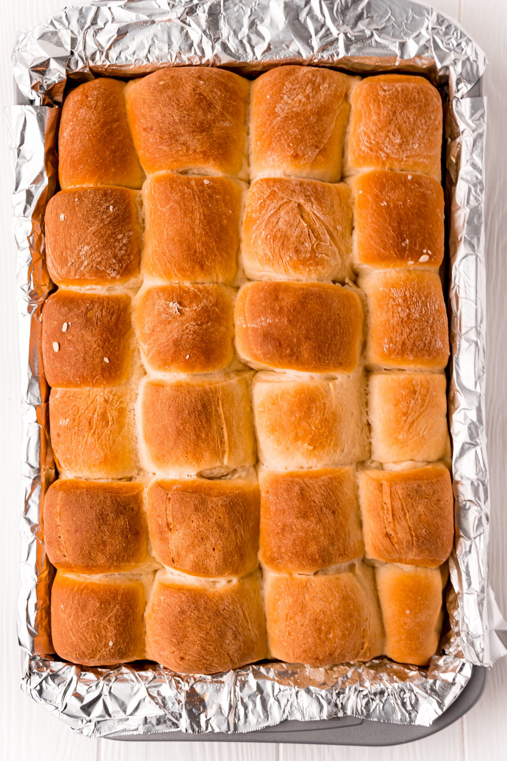 picture of baked dinner rolls on baking sheet lined with foil