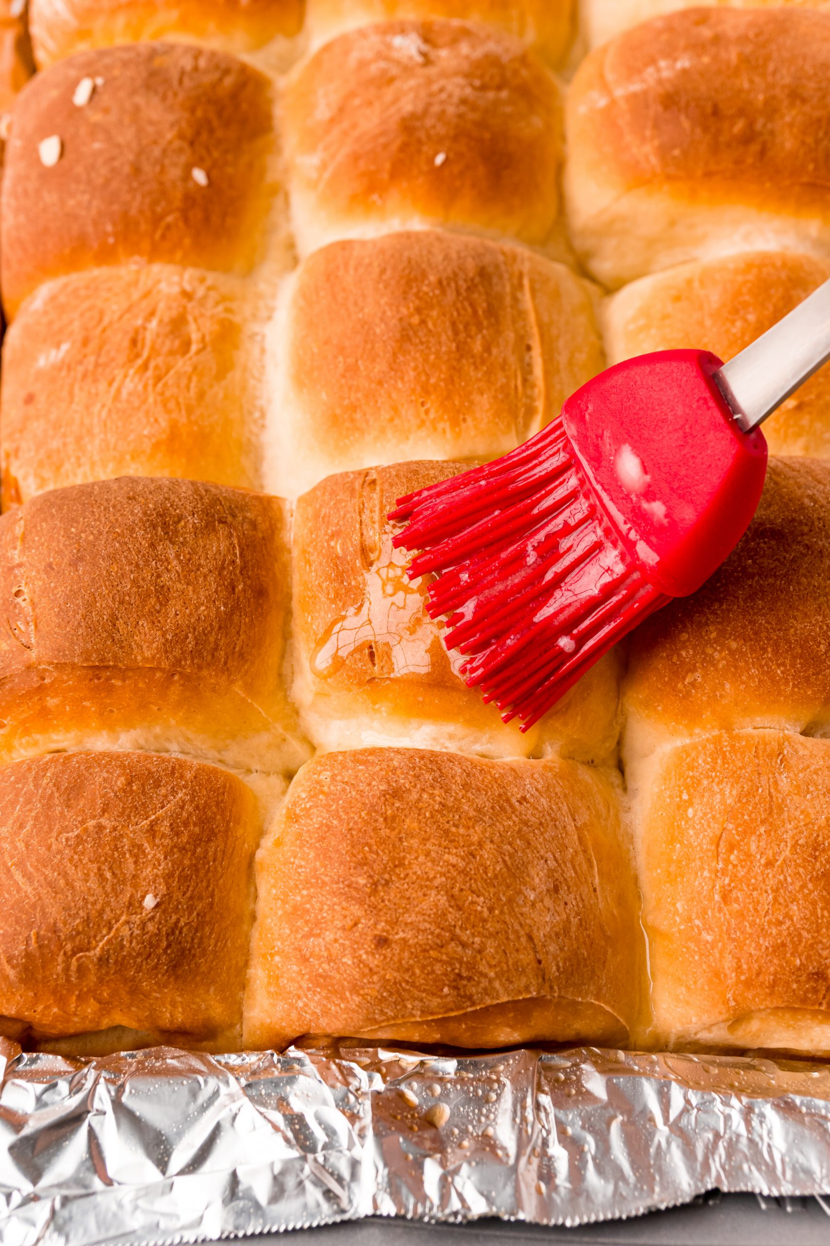 picture of pastry brush brushing butter on dinner rolls