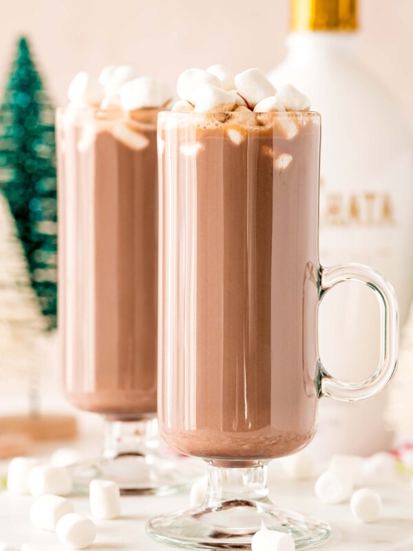 Two glasses of hot chocolate with marshmallows on top, made using the RumChata Hot Cocoa Cocktail Recipe.