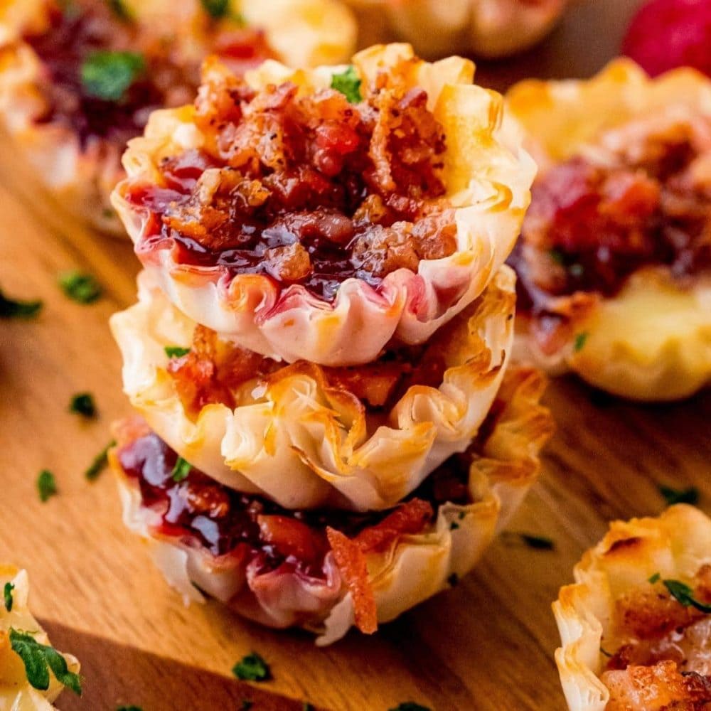 A stack of bacon and cheese tarts, perfectly golden and inviting, ready to be served.