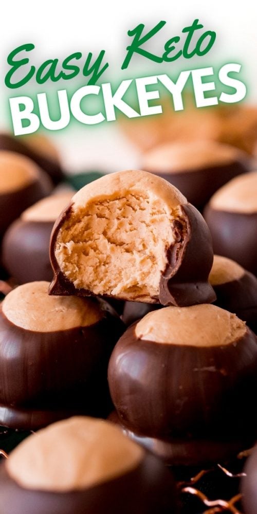 keto peanut butter balls dipped in chocolate on a wire rack, one with a bite taken out of it