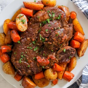 Roast beef with potatoes on a white plate, prepared using the Instant Pot.
