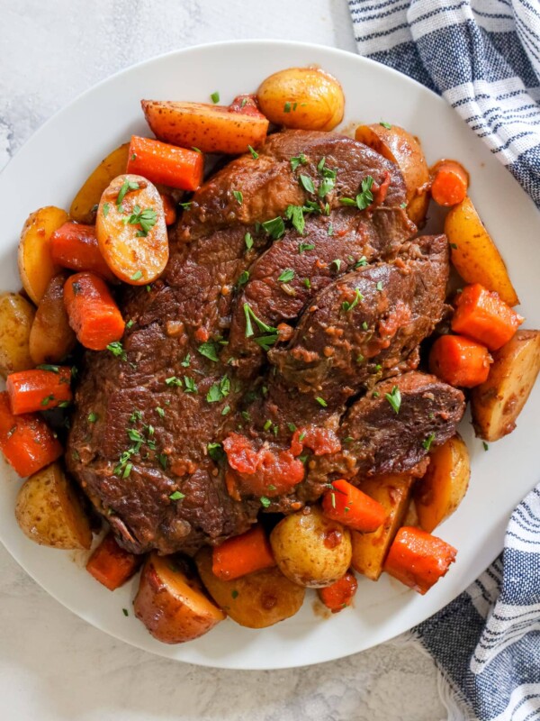 Roast beef with potatoes on a white plate, prepared using the Instant Pot.