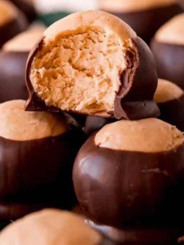 chocolate peanut butter ball dipped in chocolate stacked on a wire rack