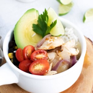 Instant Pot Chicken Fajita Bowls Recipe featuring chicken, avocado, tomatoes and limes.