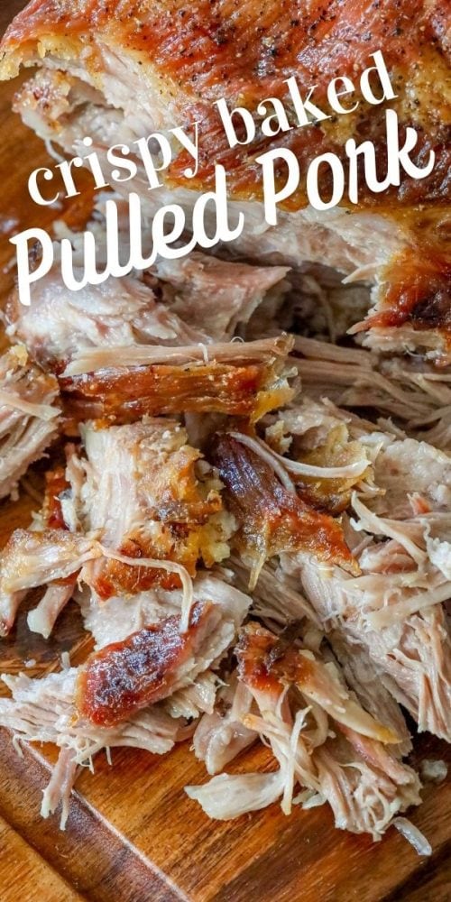 pulled pork with crunchy skin shredded on a cutting board