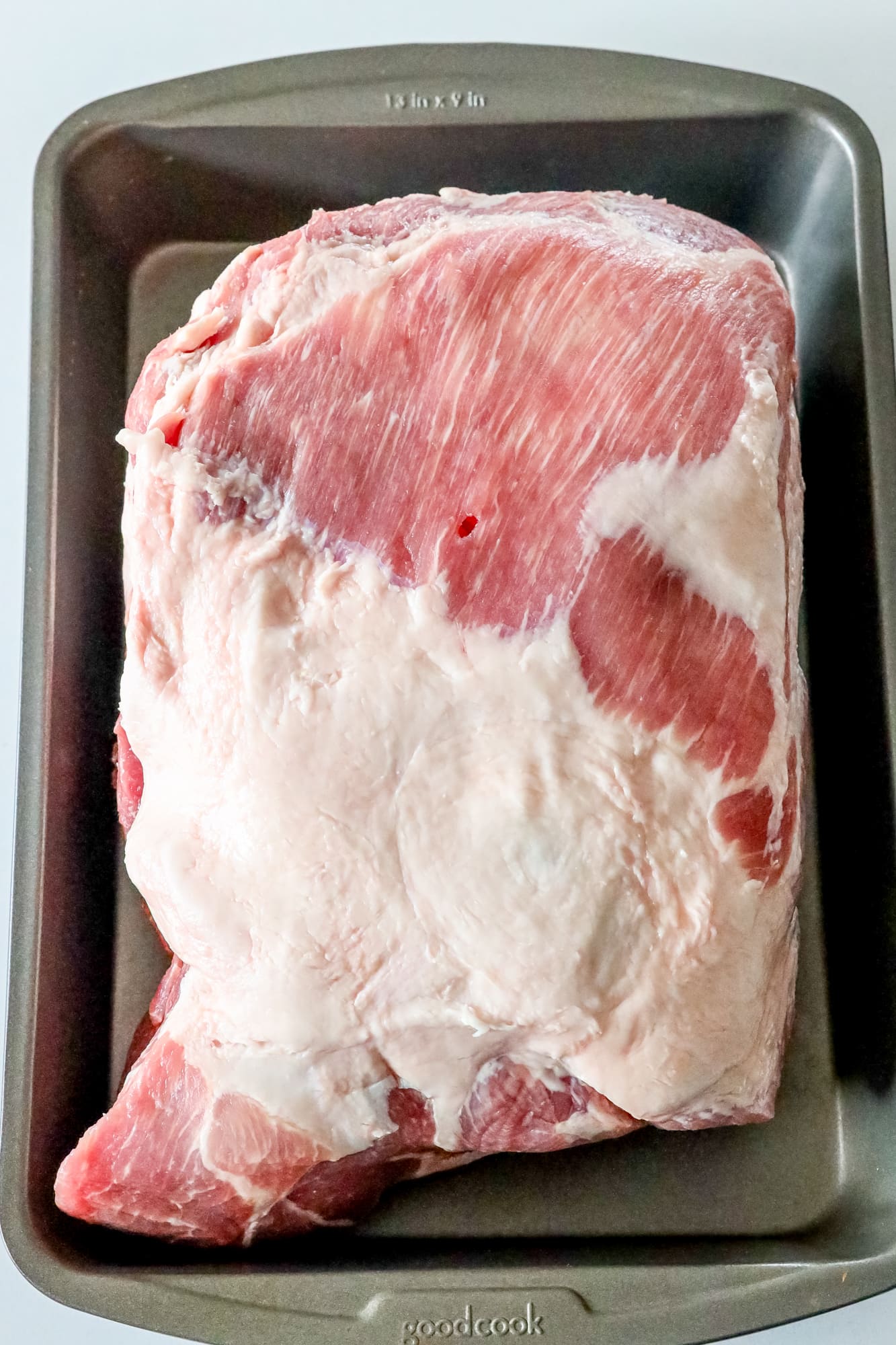 picture of raw pork shoulder in a pan