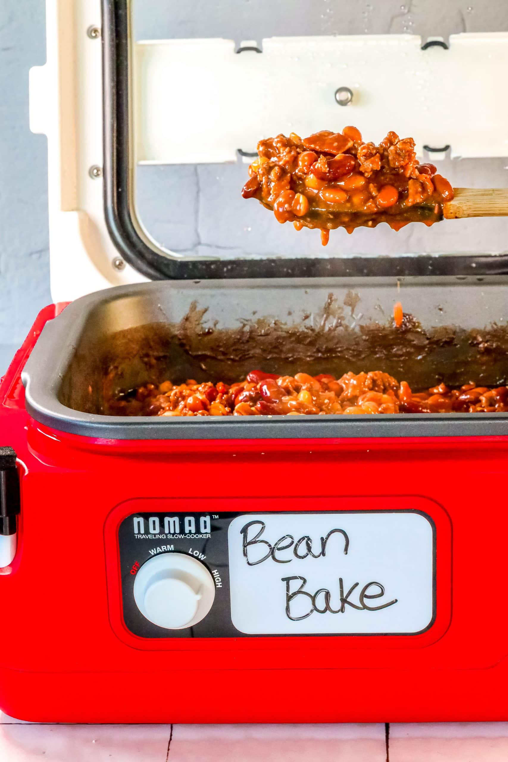 An easy slow cooker bean bake in a red oven.