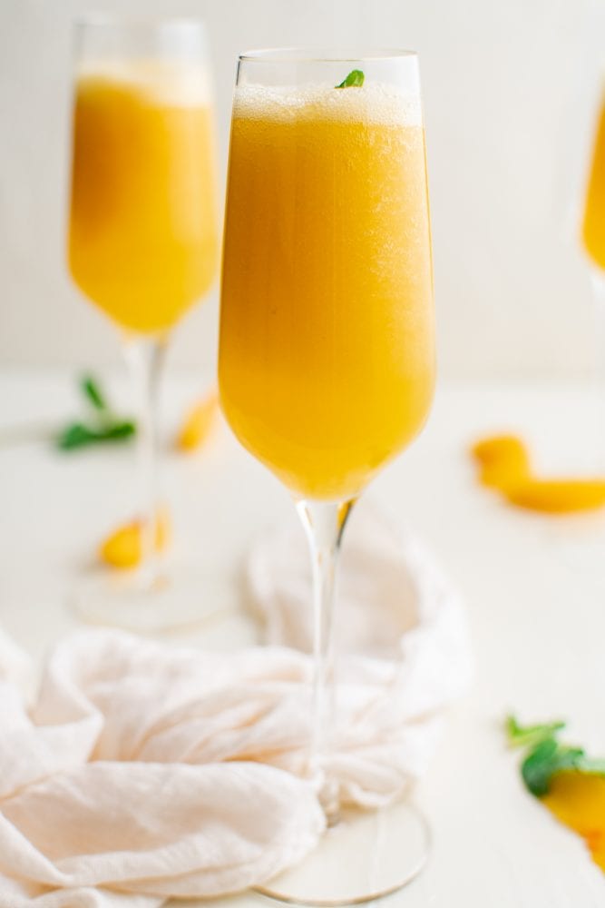 picture of peach bellinis in a champagne glass