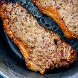 picture of steaks in an air fryer basket