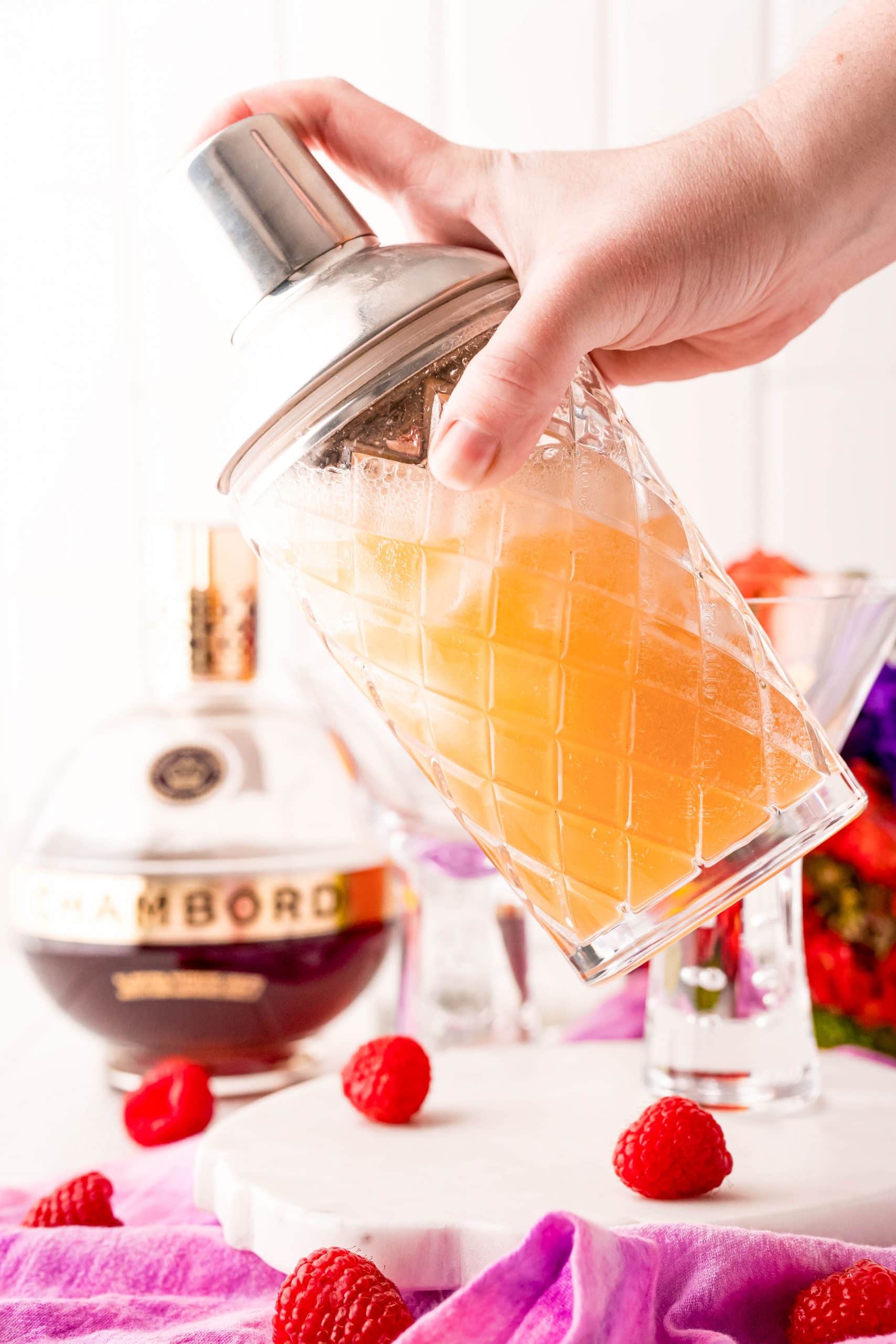orange cocktail being mixed in a mixer