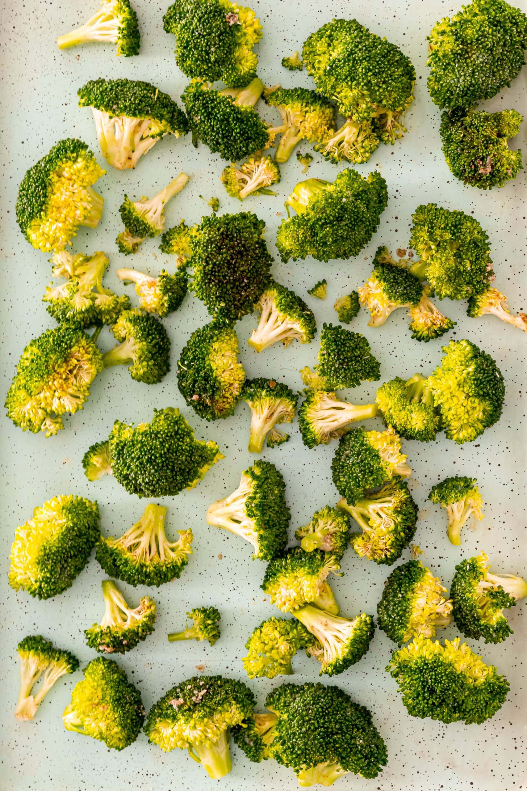 partially baked broccoli on parchment paper