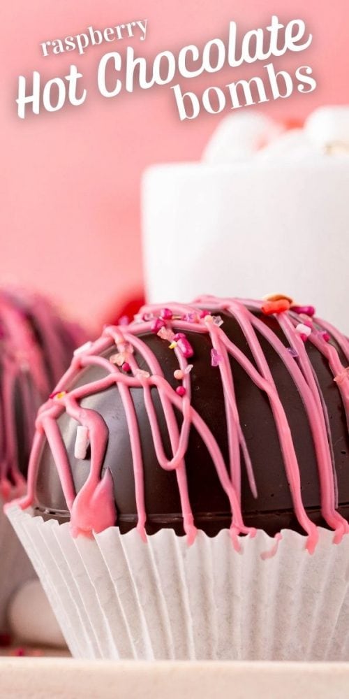 several chocolate balls with pink frosting and sprinkles on it