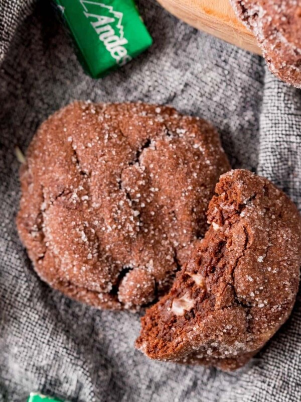 A double chocolate mint cookie with a bite taken out of it.