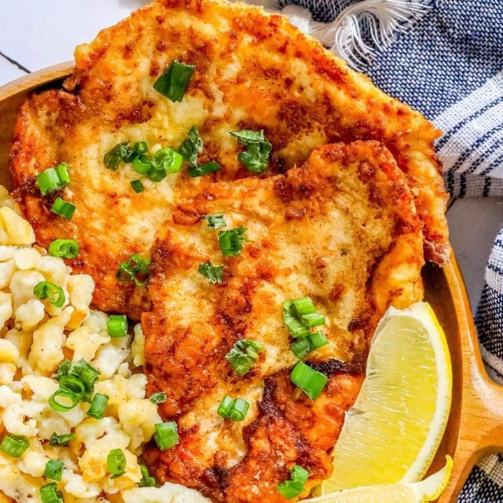 picture of schnitzel on a plate with a lemon wedge