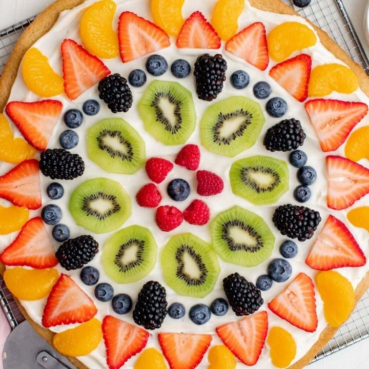 An easy homemade fruit pizza topped with berries and kiwis.