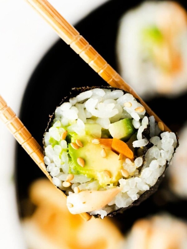 Japanese sushi rolls with chopsticks on a plate, prepared using an easy vegan sushi recipe.