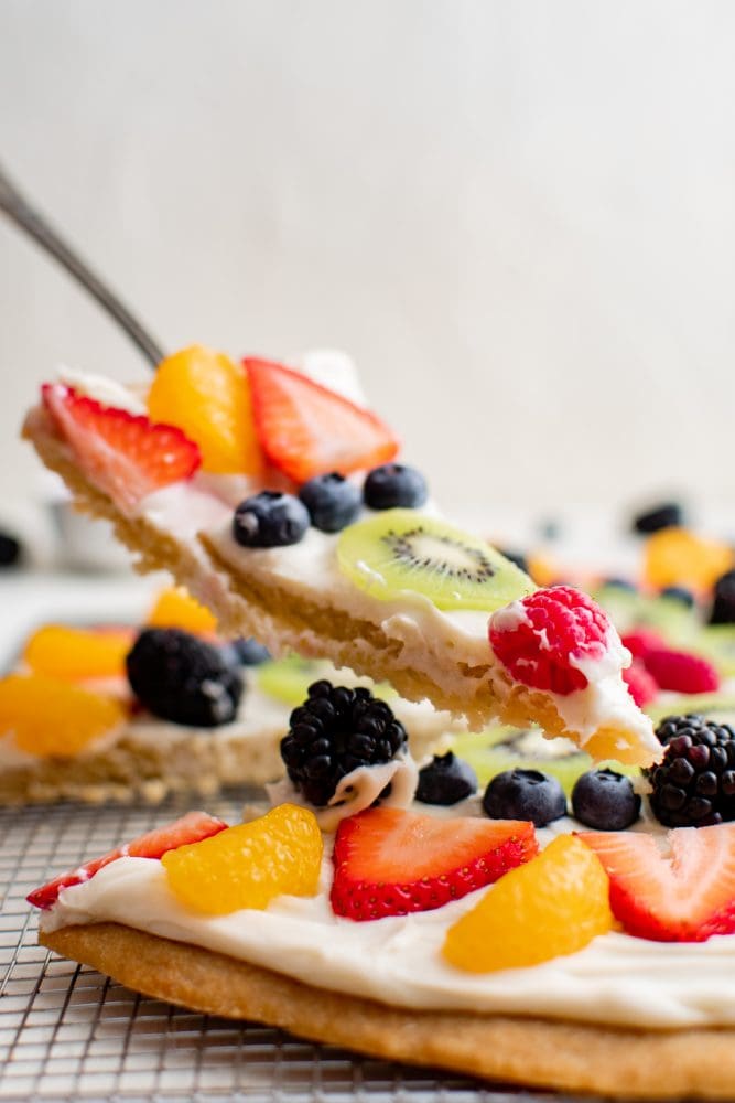 slice of cookie with whipped cream and fruit on it