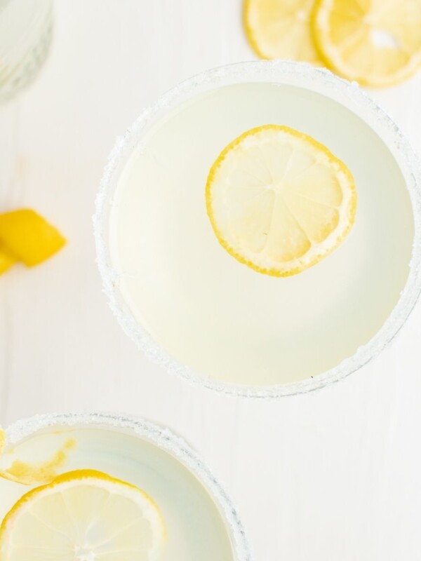 Lemon margaritas with a slice of lemon, perfect for a refreshing twist on the classic lemon drop martini recipe.