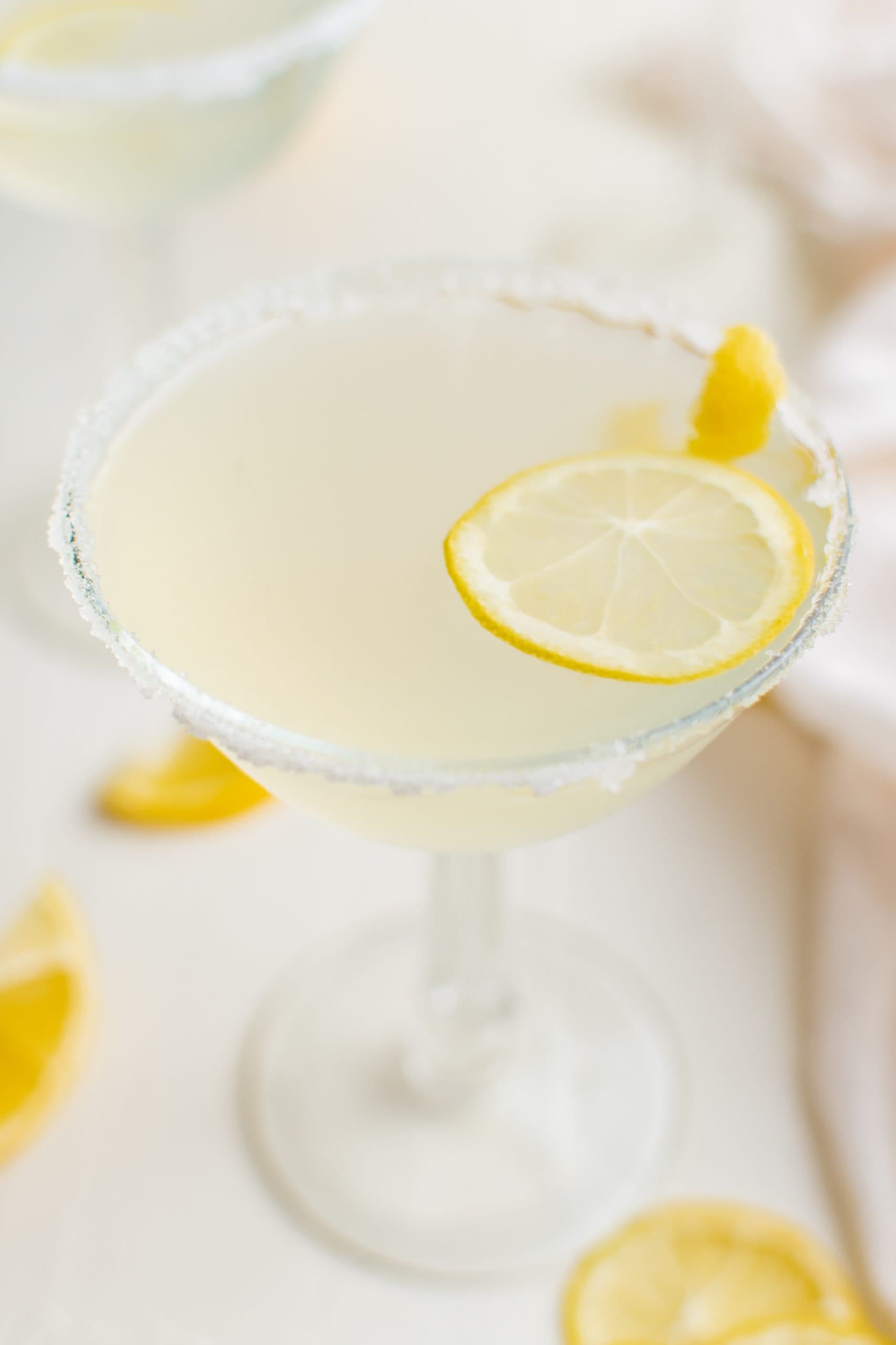 A lemon drop martini recipe with garnishes.