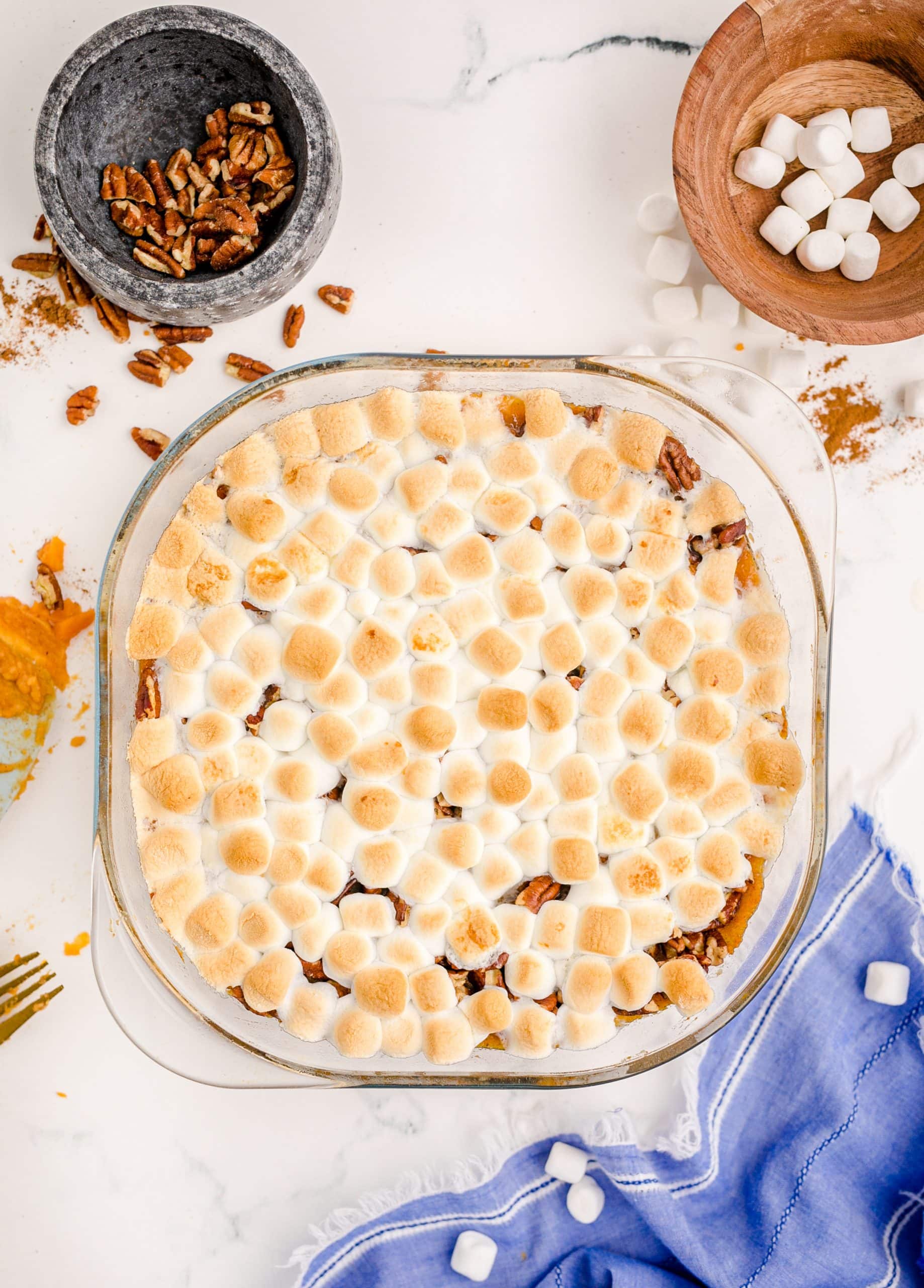 An easy to make sweet potato casserole with a s'mores dessert served in a glass dish.