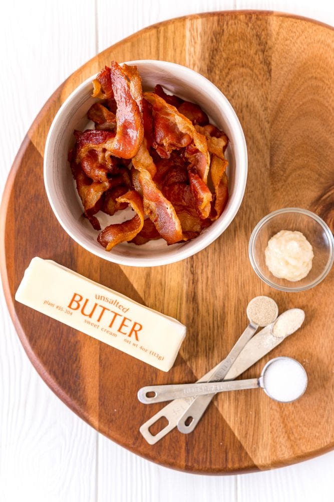 picture of bacon, butter, and garlic on a wood cutting board
