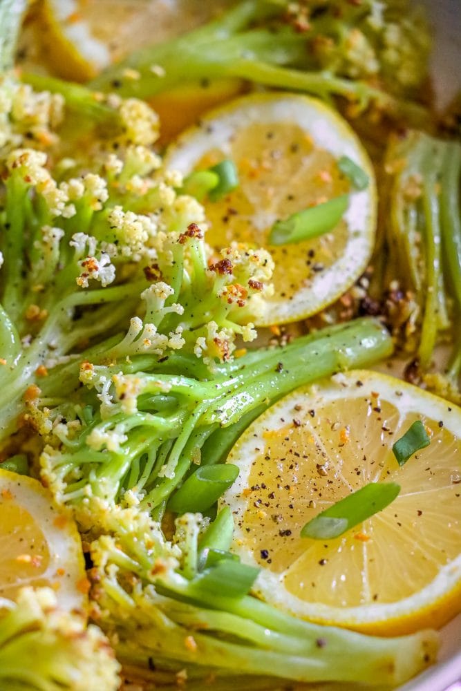 baby cauliflower and lemon slices in a white bowl 