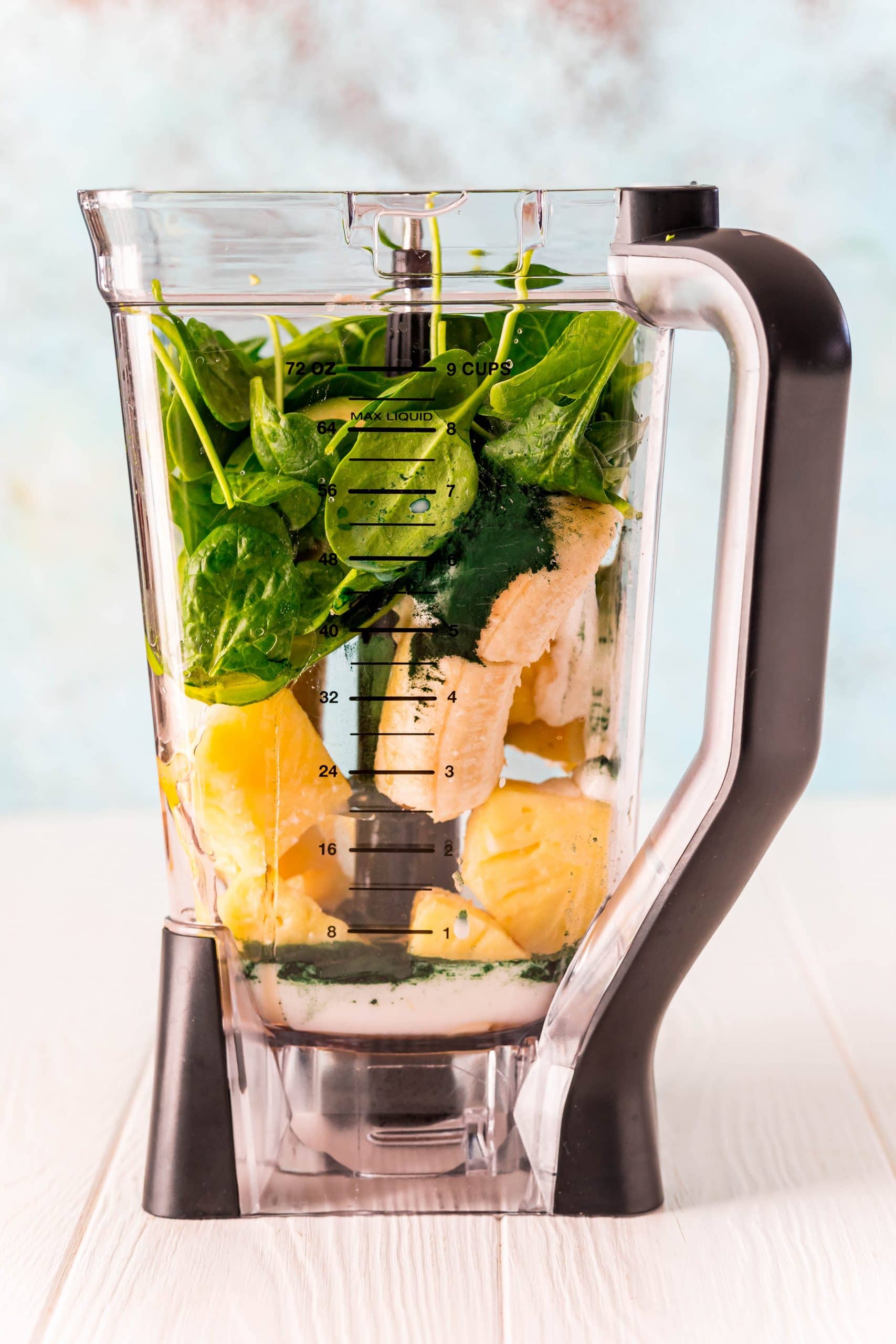 A healthy green smoothie filled with spinach and other vegetables.