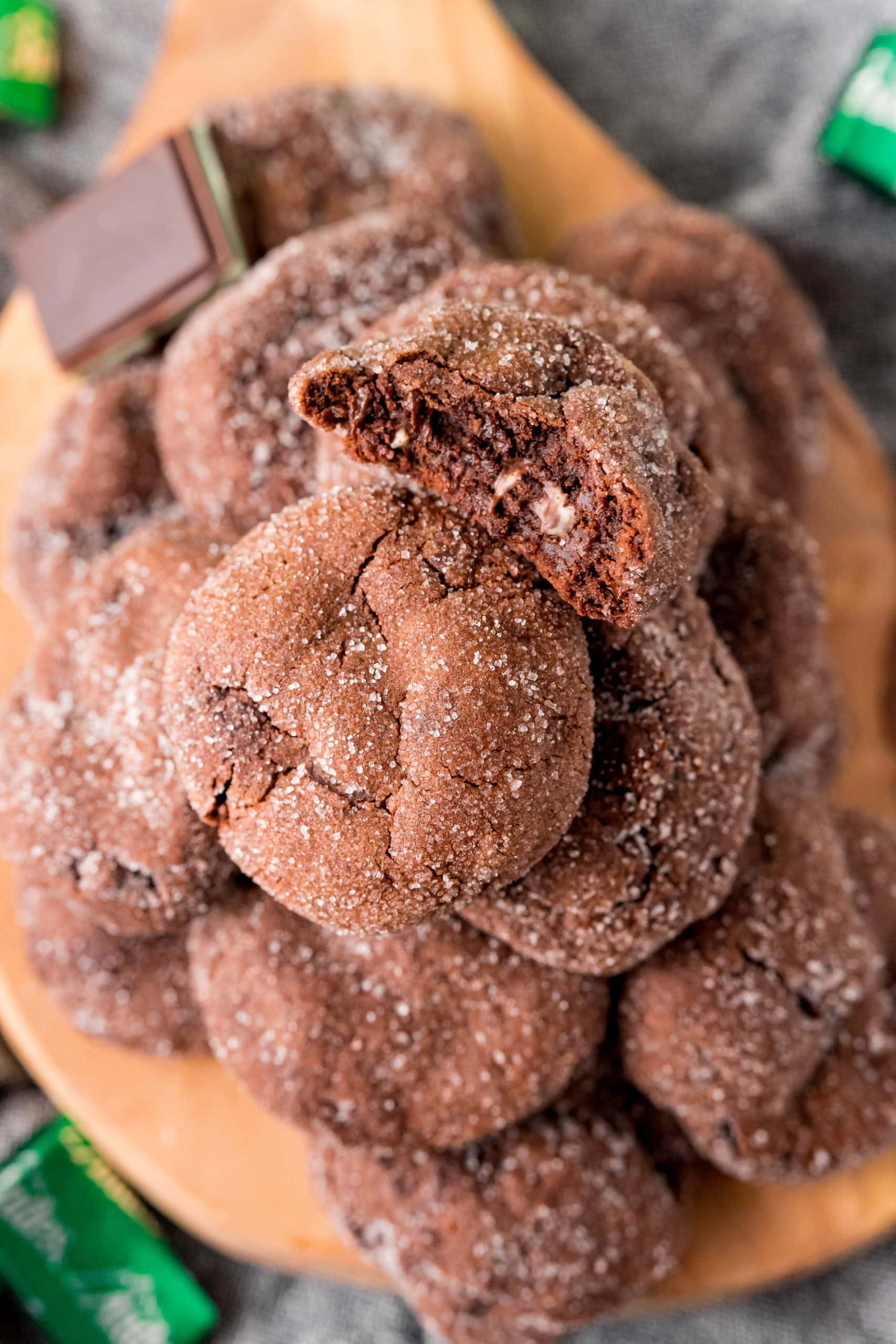 Chocolate cookies on a wooden cutting board.