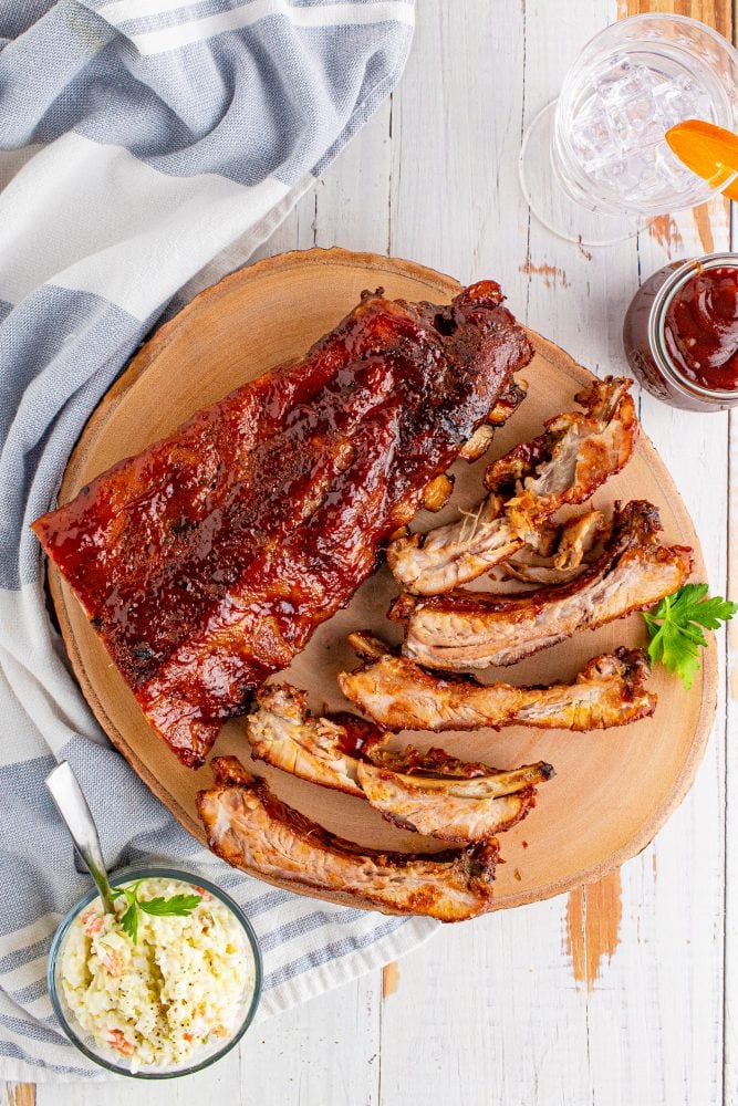 ribs on a plate with coleslaw next to it
