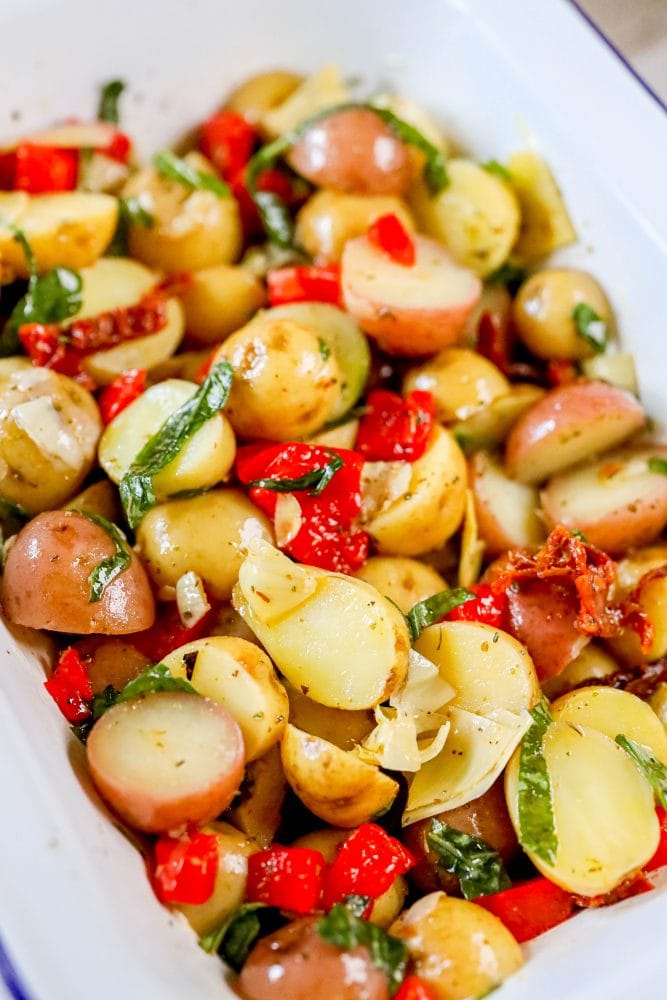 picture of potatoes, basil, artichokes, sun dried tomatoes, and roasted red peppers in a bowl 