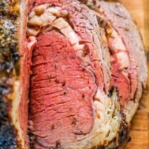 picture of sliced ribeye roast on a wood cutting board